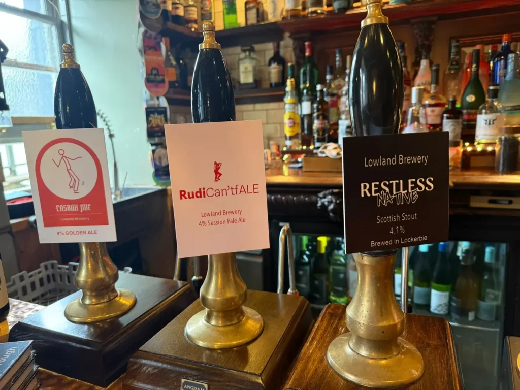 Cask ale pumps on the bar at the Black Bull Inn, Moffat